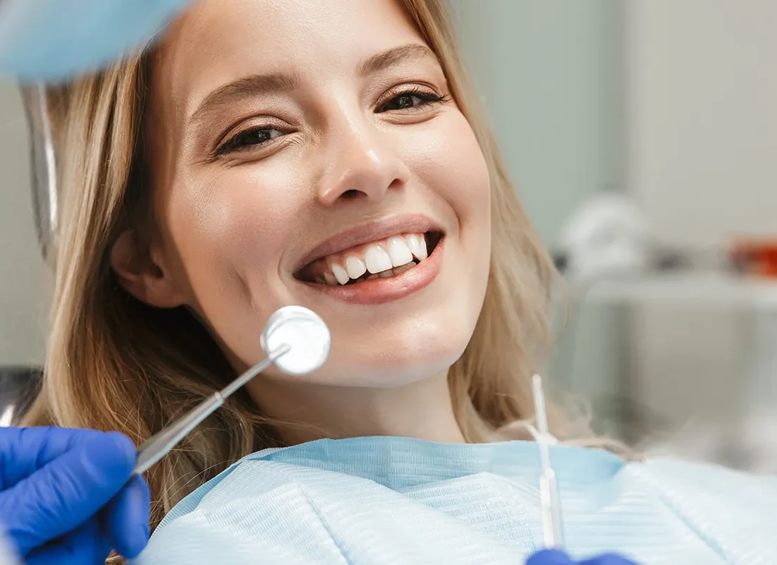 A patient smiling in the dental chair after a checkup